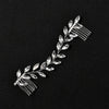 Une délicate peigne pour cheveux de mariée en cristal avec de petites feuilles scintillantes.