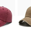 A pair of casual baseball caps, one in maroon and one in olive green, shown from the side.
