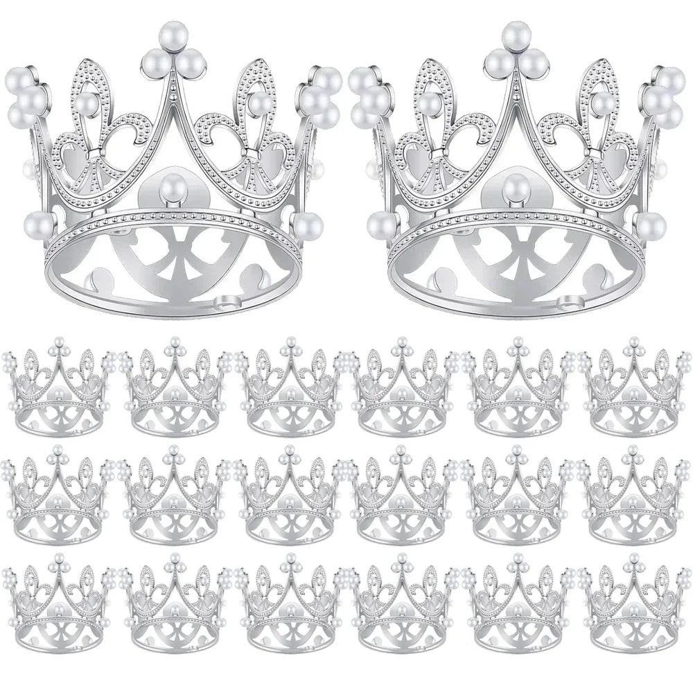 A collection of silver mini crown cake toppers for parties.