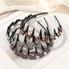 Black hair accessory featuring multiple rhinestone butterfly clips arranged in a curved line.