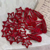 A collection of red star-shaped snap clips for hair and barrettes