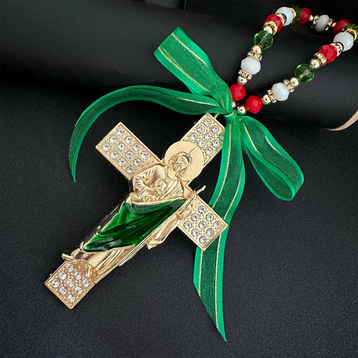 Gold and green Catholic charm featuring a figure of the Virgin Mary or Saint Jude with a beaded green ribbon