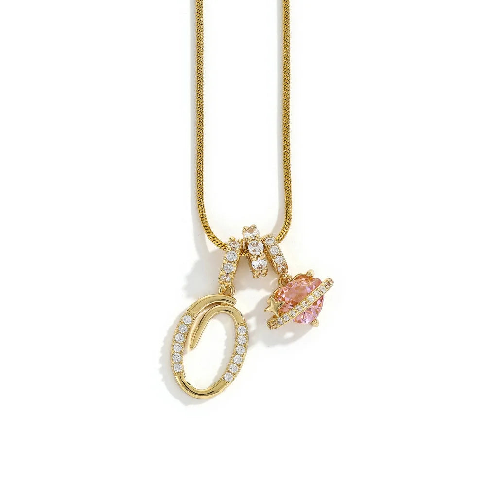 A gold chain necklace featuring an alphabet flower pendant and a circular gold charm.