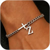 A close-up of a personalized stainless steel cross Cuban chain bracelet worn on a wrist.