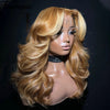 A model wearing a long, wavy honey blonde lace front wig with voluminous layers.