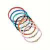 A collection of colorful resin beaded bracelets in various shades including blue, orange, pink, and black.