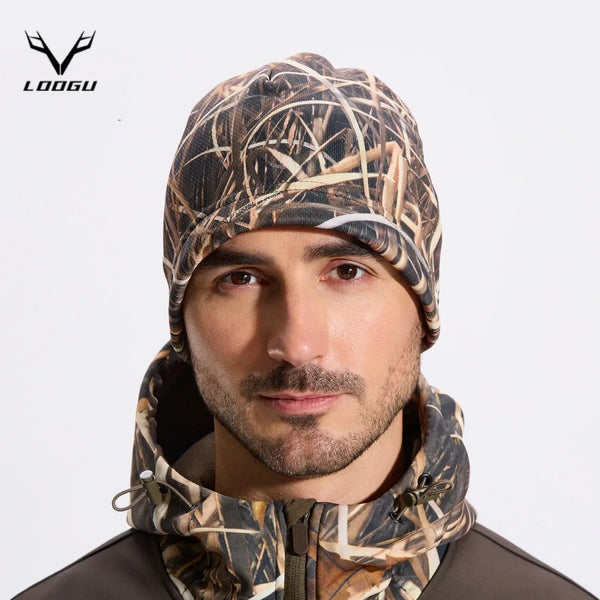 A man wearing a camouflage thermal beanie and neck gaiter for outdoor activities.