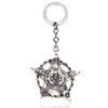 Silver skull pendant necklace for women with a circular charm.