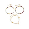 A set of bohemian anklets featuring strings of white and colored seed beads.