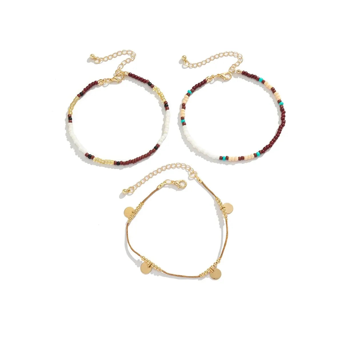A set of bohemian anklets featuring strings of white and colored seed beads.