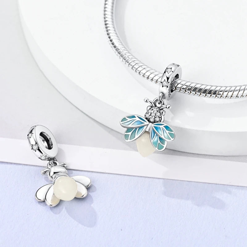 Sterling silver devil's eye charm bracelet featuring a leaf pendant and a delicate chain.
