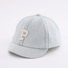A light gray denim baseball cap with a tan embroidered initial P