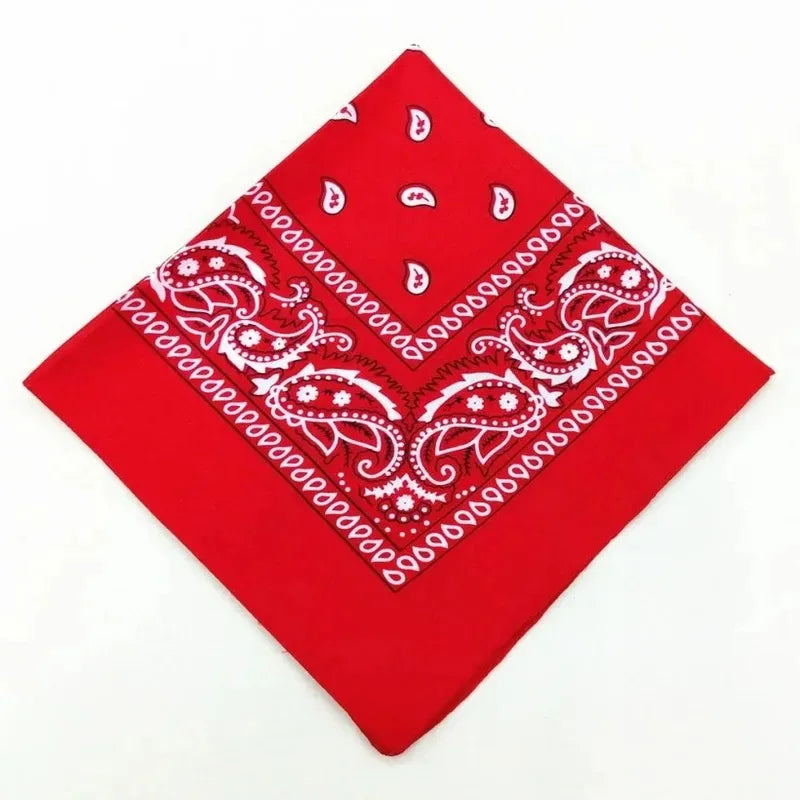 A red cotton bandana scarf featuring white paisley and geometric patterns.