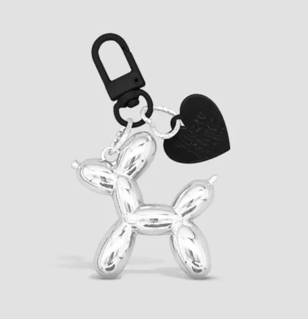 Silver cartoon dog keychain with a black carabiner clip