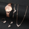 A set of rose gold quartz wrist watch and necklace with diamond accents displayed on a black background.