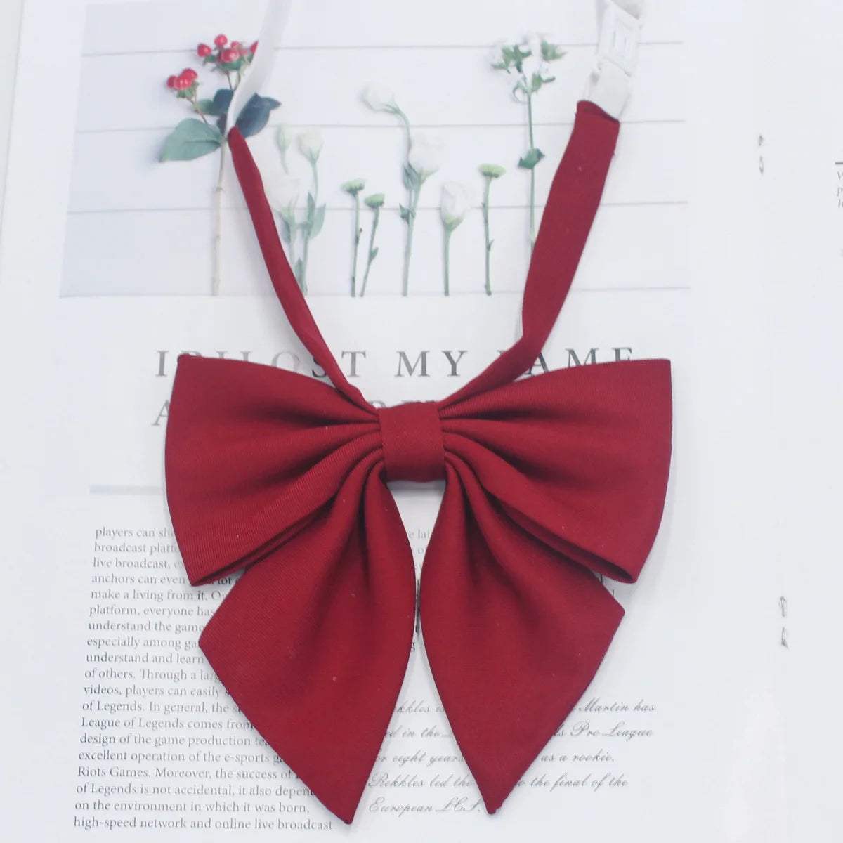 A solid red cotton bow tie tied in a bow shape, displayed against a white background.