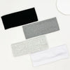 A set of four knitted hair bands in black, gray, and white are displayed on a white background.