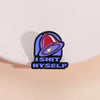 A vintage enamel pin featuring a red bell and the text ISHIT MYSELF in blue and black.