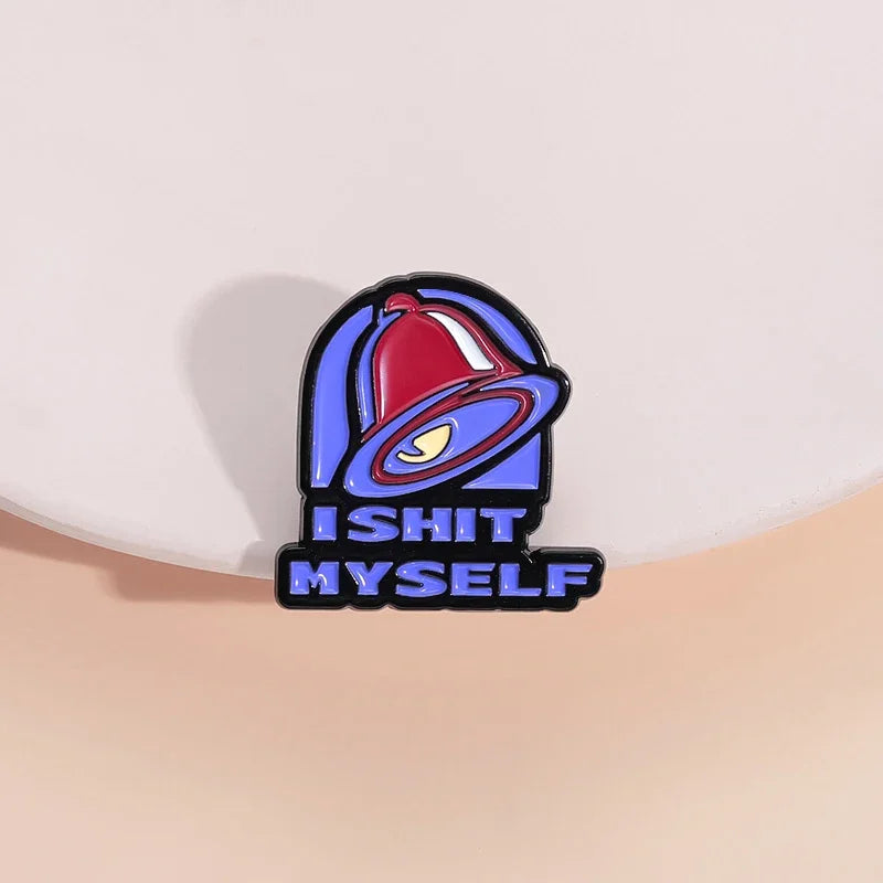 A vintage enamel pin featuring a red bell and the text ISHIT MYSELF in blue and black.