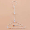 A delicate silver multilayer vintage ball link finger bracelet displayed on a neutral background.