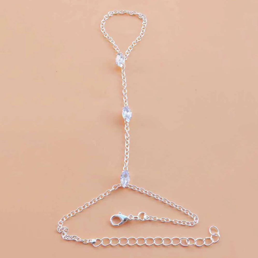 A delicate silver multilayer vintage ball link finger bracelet displayed on a neutral background.
