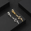 Gold and silver fashion belly button rings displayed on a black surface.