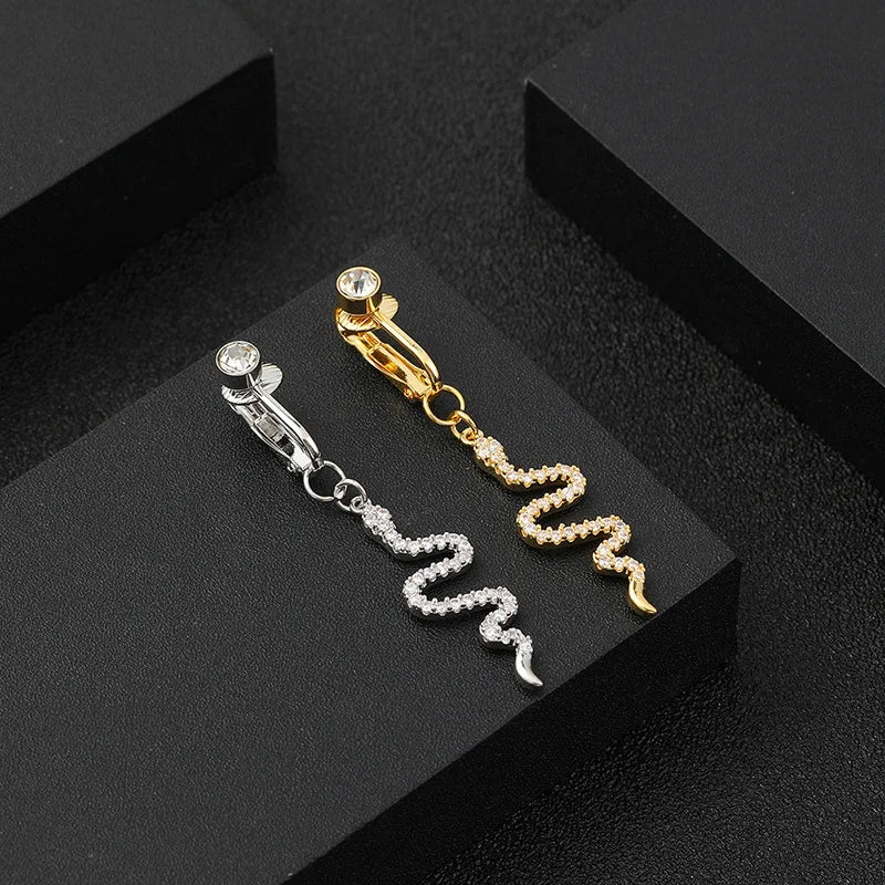 Gold and silver fashion belly button rings displayed on a black surface.