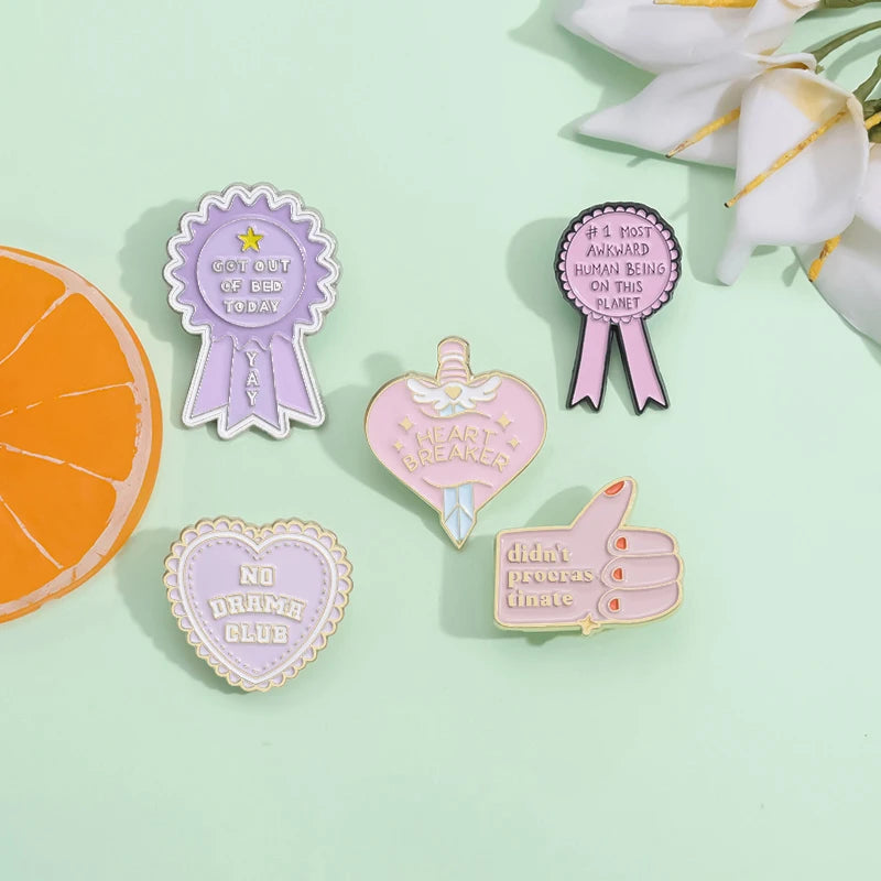A set of enamel pins featuring funny quotes and awards on a light green background.