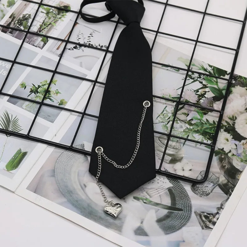 A black classic chain necktie with a silver chain and pendant displayed on a grid of nature photos.