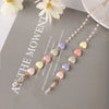 A delicate fashion pearl beaded eyewear chain featuring pastel colored beads like pink, yellow, and purple.