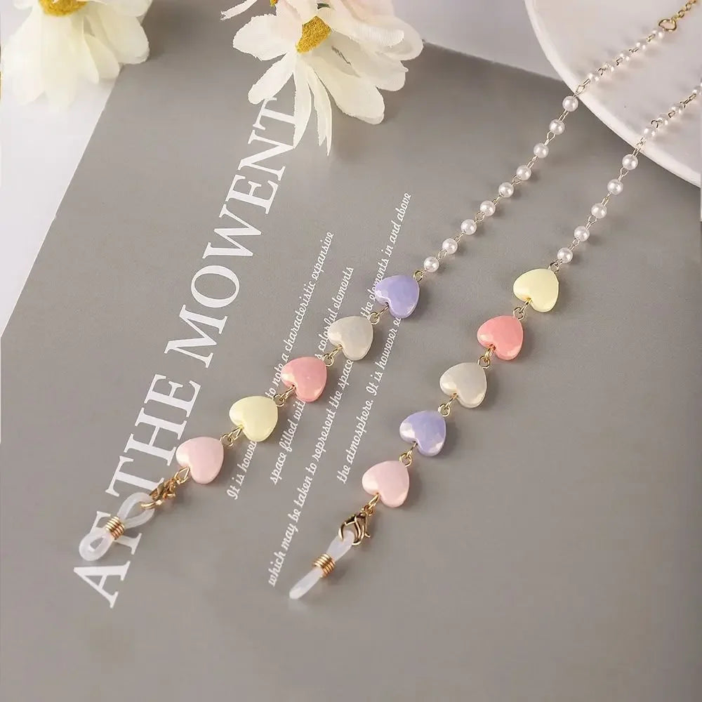 A delicate fashion pearl beaded eyewear chain featuring pastel colored beads like pink, yellow, and purple.