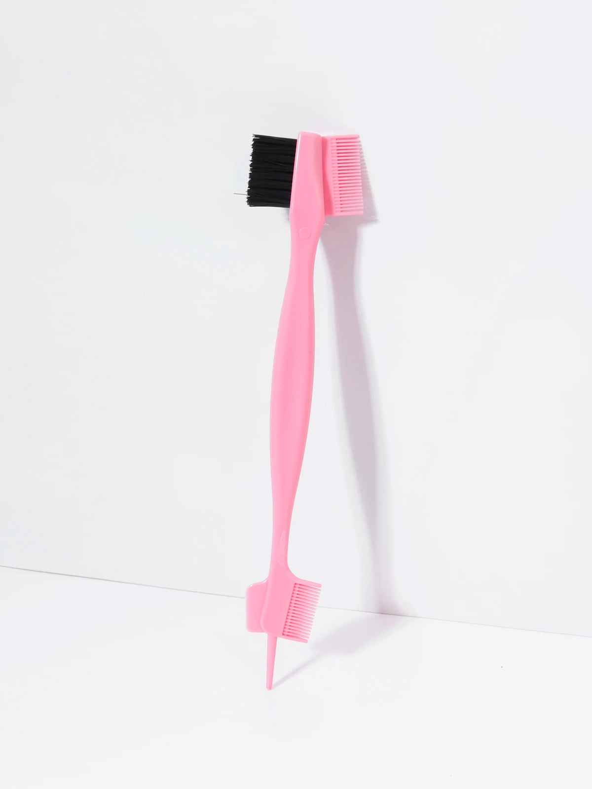 A pink precision edge control hair combing set with black bristles and teeth.