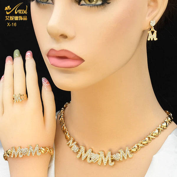 A close-up of a woman wearing gold heart crystal jewelry set including earrings and a necklace.