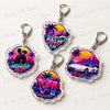 Three iridescent keychains featuring neon palm trees and cityscapes with the text Midnight Heist, Palm Rush, and Neon Coast.
