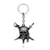Silver skull pendant necklace with a circular bail and a small dagger charm.