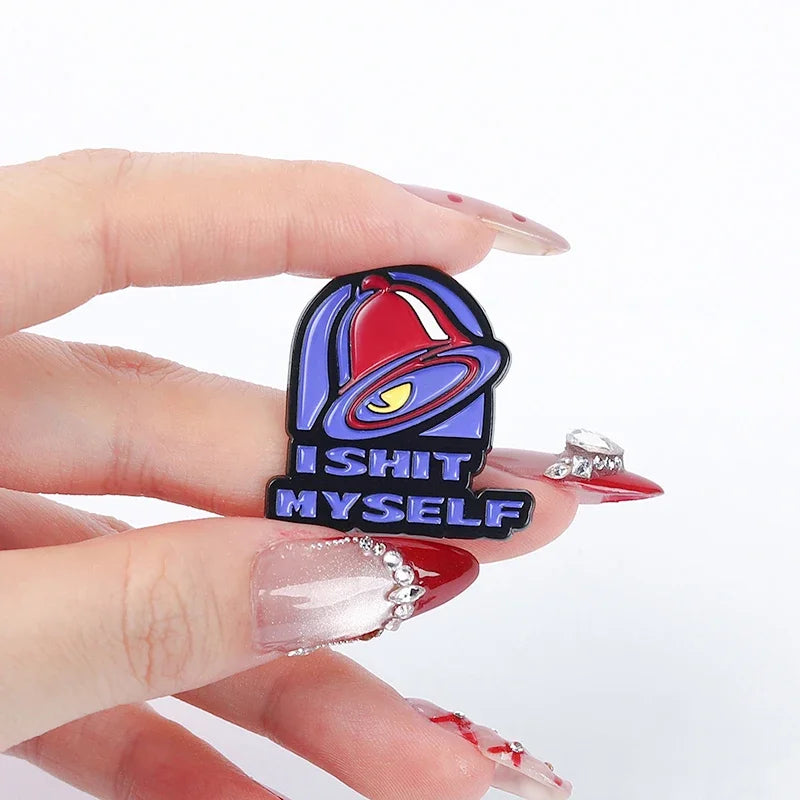 A hand holds a vintage enamel pin featuring a bell design and the text IS IT MYSELF.