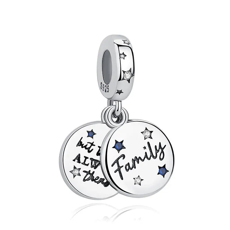 A silver family tree charm jewelry piece featuring a star design and the words bit it and they family.