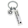Silver keychain with a D initial charm and the text Drive Safe I need you here with me