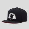 Black unisex adjustable snapback cap featuring a white All-In hand symbol on the front.