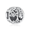 A silver charm featuring an intricately detailed family tree design.