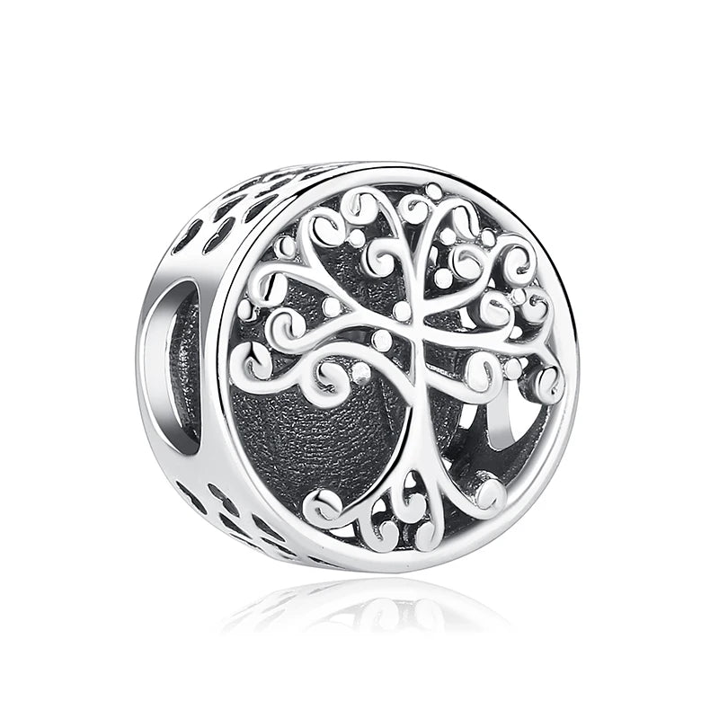 A silver charm featuring an intricately detailed family tree design.
