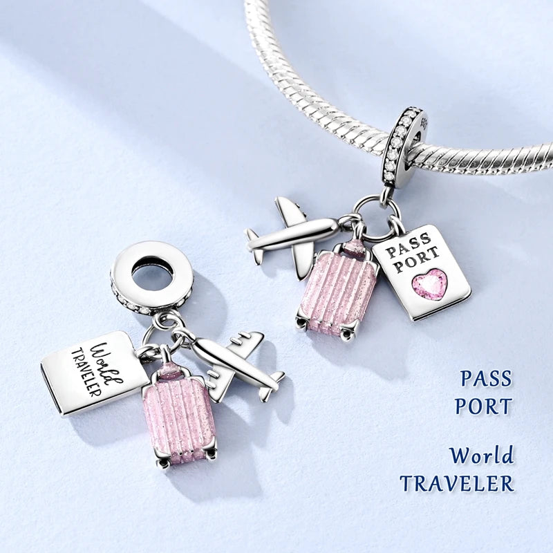 Sterling silver charm bracelet featuring a passport and airplane charms on a silver chain.