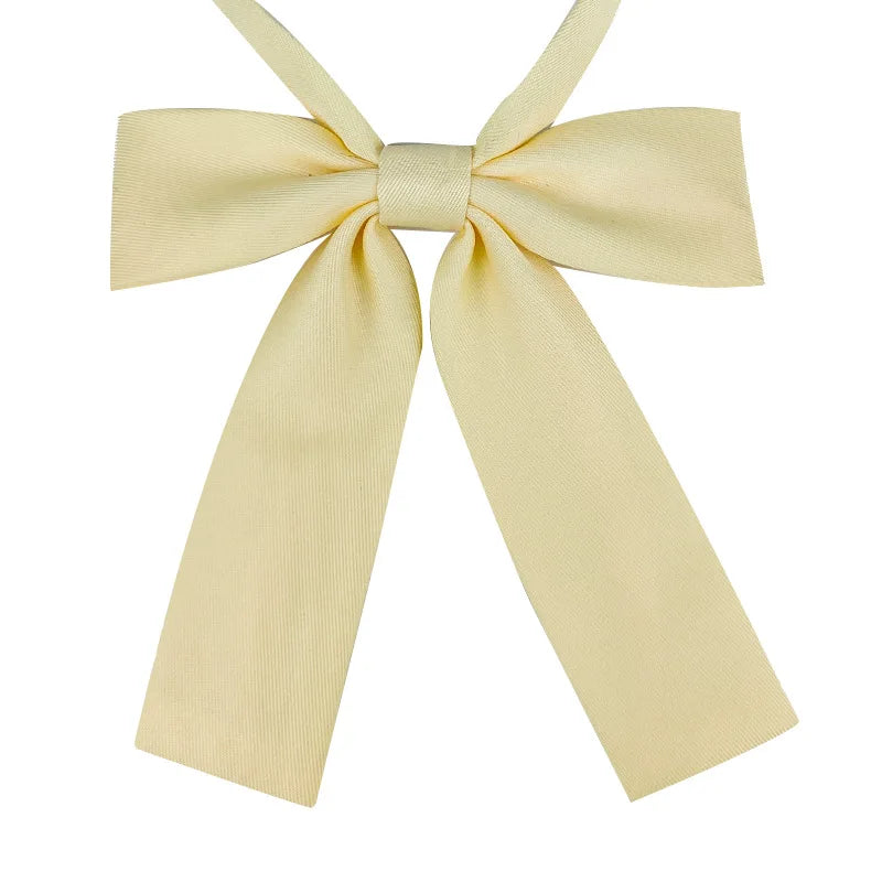 A pale yellow butterfly ribbon tie set with a bow and two long ribbons.