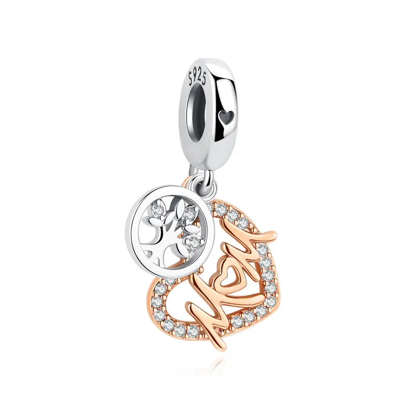 A silver charm featuring a family tree design and the initials 'Mom' set in small diamonds.