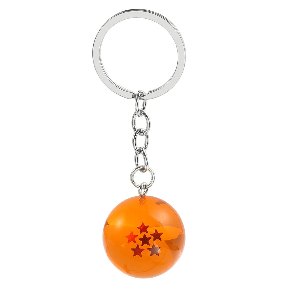An orange spherical keychain with red stars attached to a silver keyring.