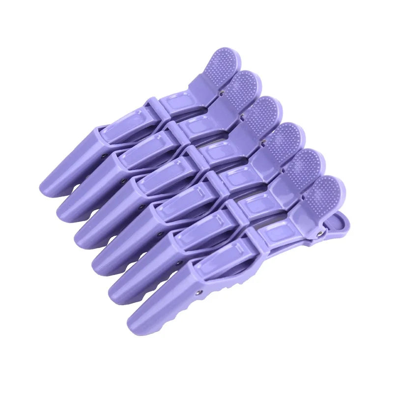 A set of six purple alligator hair sectioning clips arranged in a fan shape.