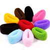 A collection of multi-colored cotton elastic hair ties in shades of yellow, brown, black, pink, and purple.