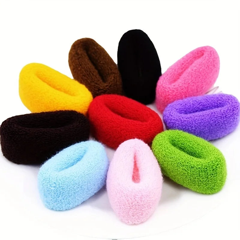 A collection of multi-colored cotton elastic hair ties in shades of yellow, brown, black, pink, and purple.