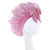 A pink satin wide-brimmed hair wrap headscarf tied in a bow displayed on a white mannequin.