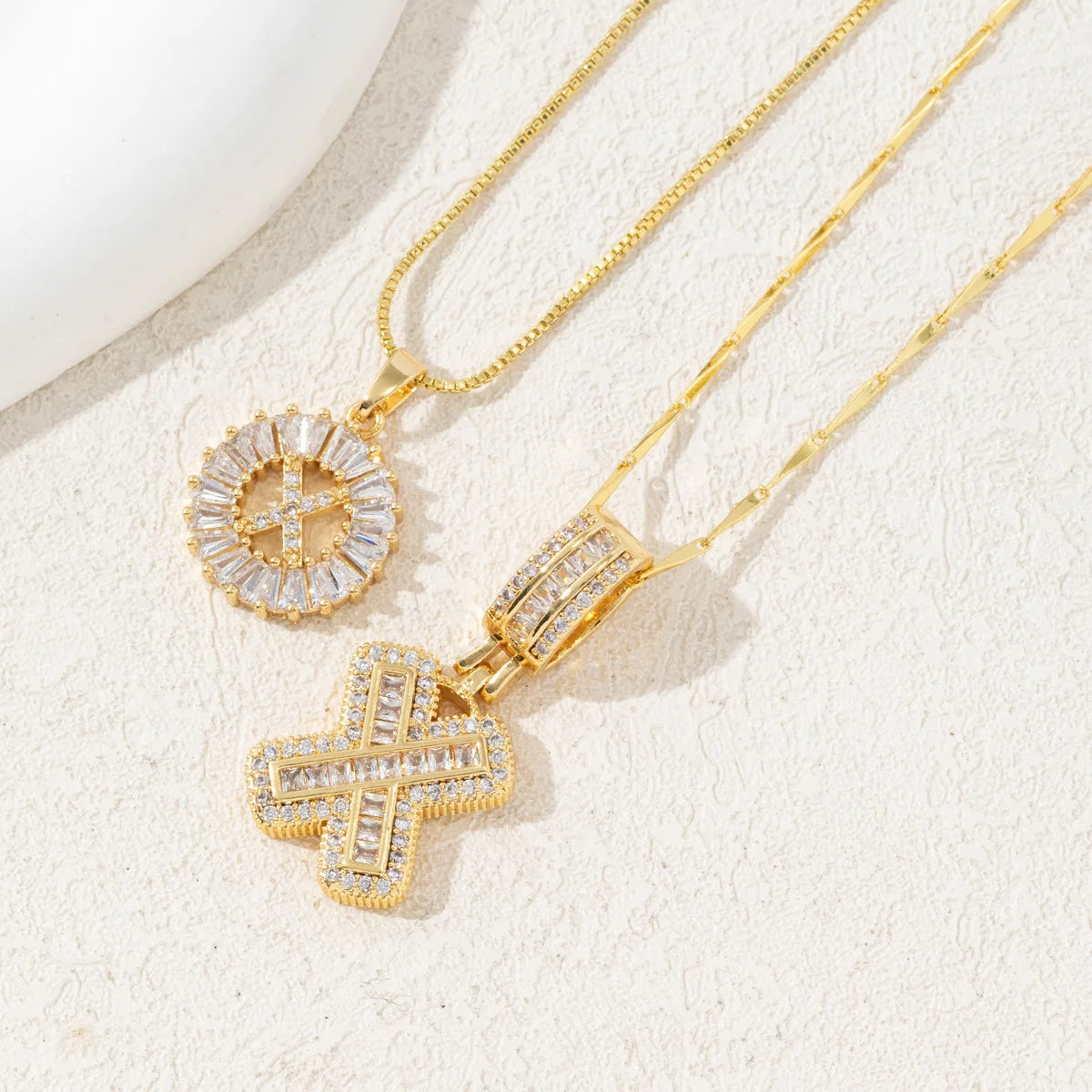Gold-toned necklace set featuring CZ crystal pendants shaped like letters and crosses.